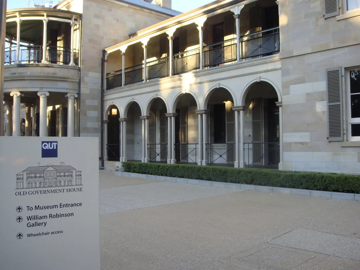 Concrete forecourt in front of an arched heritage-style building