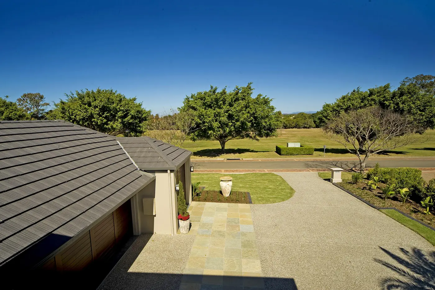 Exposed driveway with sandstone entry