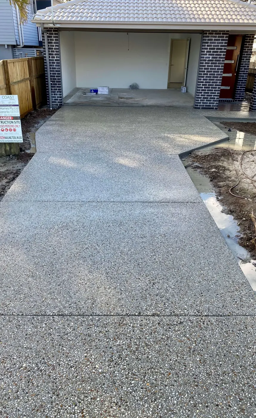 Concrete driveway running from a garage to the street
