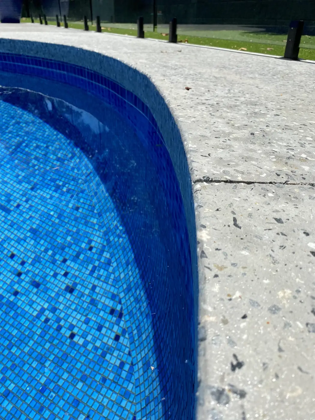 Honed infinity edge pool coping