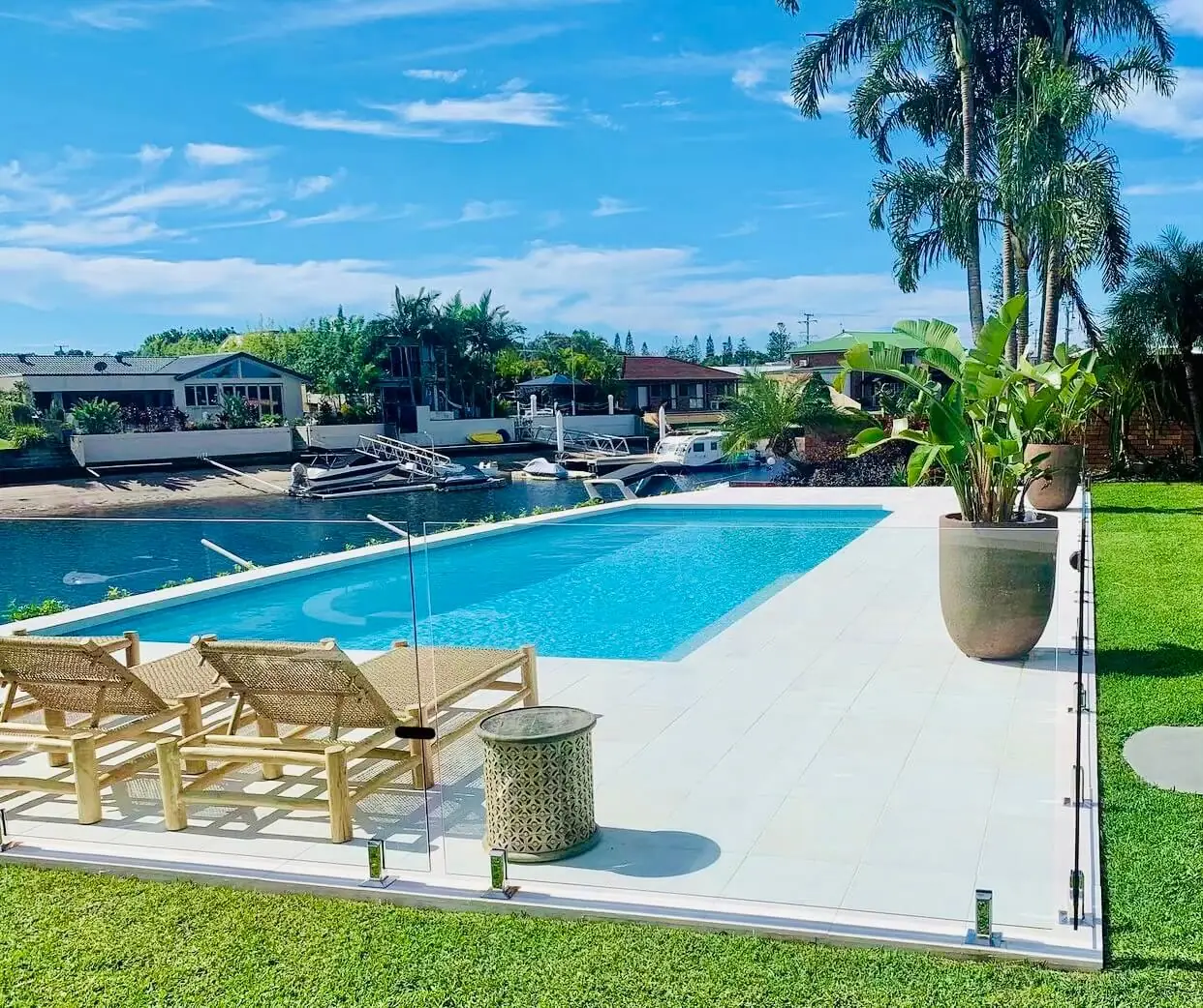 Light concrete pool surround on a Gold Coast canal block