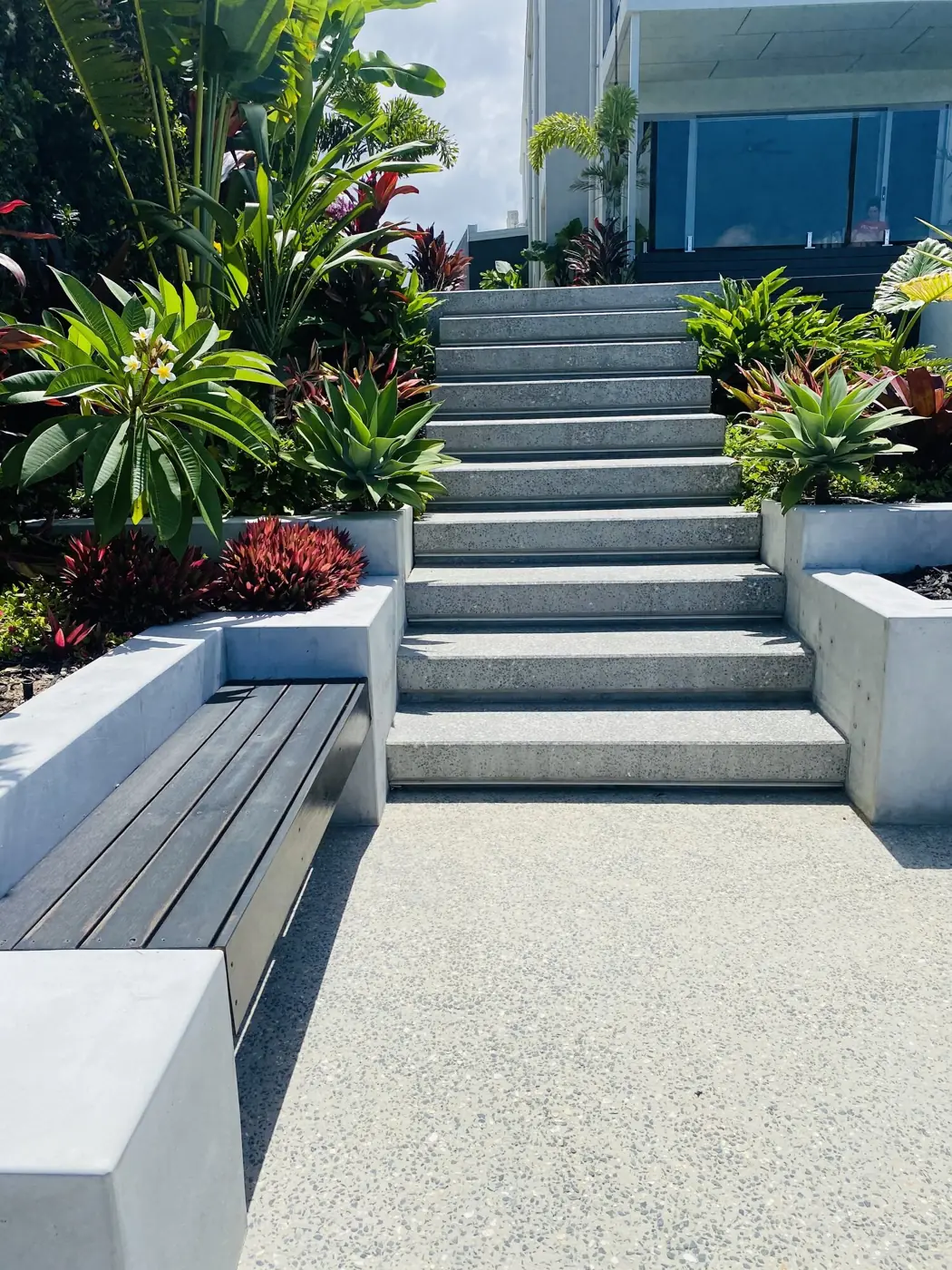 Wide concrete stairs through a garden